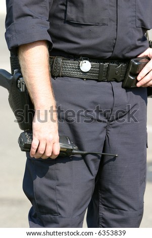 a close up of a police man holding his radio