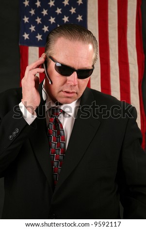 a Secret Service Agent speaks on his ear piece