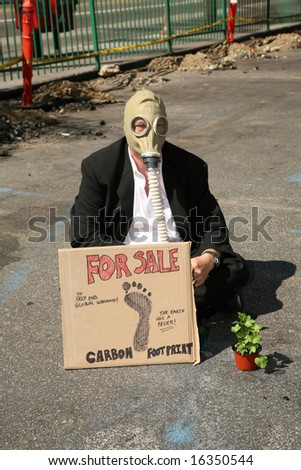 Global Warming concepts. a Business Man wears a Gas Mask and offers to sell his Carbon Footprint to help end Global Warming