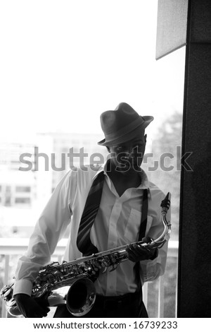 a cool cat takes a quick break from playing his sax in these moody images