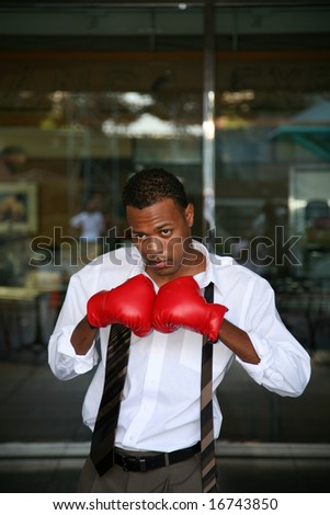 a young boxer poses with his boxing gloves for the press before the big fight