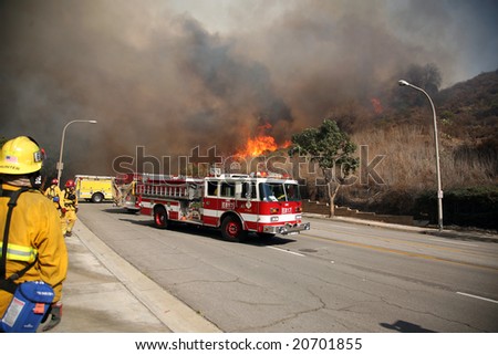 BREA, CA - NOV 15: Fire Fighters and emergency personal rush to control fires in Brea CA.  Many homes in the area have been destroyed as a result of the wildfires.