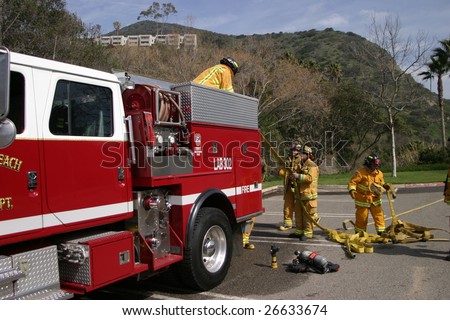 LAGUNA BEACH, CA - FEB 19: Firefighter recruits pack up after fire fighting drills at the local Fire Department training area on February 19, 2009 in Laguna Beach, California.