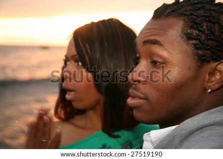 a young african american are shocked at what they see in the ocean