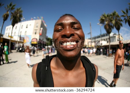 a handsome african american man smiles and poses for a unique shot taken with a 