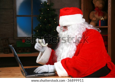 Santa Claus checks his e-mail on his laptop computer
