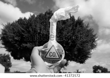 a Mad Scientist holds a 500ml beaker filled with CO2 with a paper wick as a Molotov cocktail against the sky, representing  A Global Warming Time Bomb, in black and white