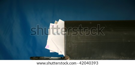 a mail box stuffed full of letters and mail
