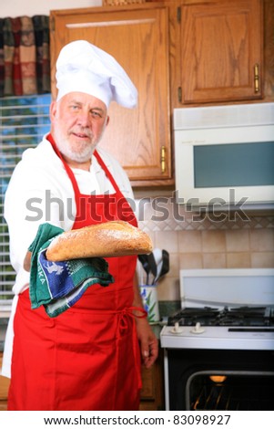 a happy chef prepares one of his famous dishes for someone while in his kitchen at a world famous bed and breakfast hotel restaurant.