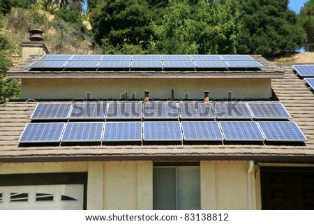 alternative energy photovoltaic solar panels on the roof of a home. collecting energy from the sun and helping save the earth from global warming and reducing their electric bills at the same time
