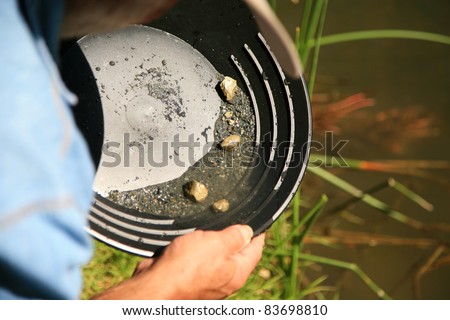 gold panning, man striking it rich by finding the mother lode or at least a nugget or two