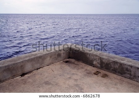 Concrete pier with a view of the ocean.