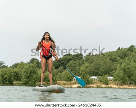 Similar – Image, Stock Photo Woman with paddleboard on shore in sea