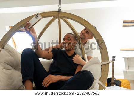 Similar – Image, Stock Photo Cheerful gay couple taking selfie on smartphone