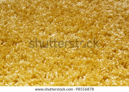 yellow carpet of artificial material close-up. The texture of the carpet