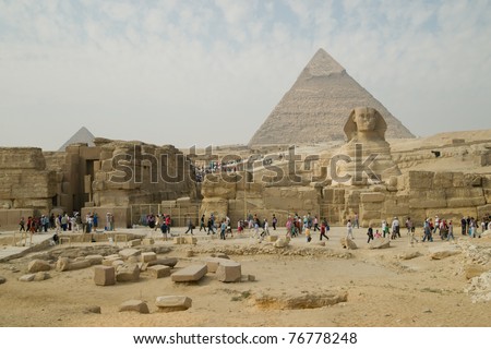 GIZA, EGYPT - NOV 15:  Tourists inspect the Pyramids and the Sphinx on November 15, 2010, at Giza, Egypt.  The world\'s oldest tourist attraction, the Pyramids of Giza are nearly 5000 years old.