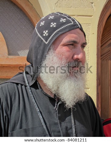 EASTERN DESERT, EGYPT - NOV 18: Coptic monk addresses pilgrims at St Anthony\'s Monastery on November 18, 2010.  Claimed as the oldest monastery in the world, it has influenced monasticism worldwide.
