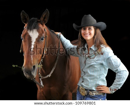 Portrait of a woman cowgirl with her horse