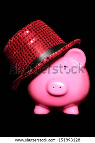 piggy bank wearing red hat on a black background