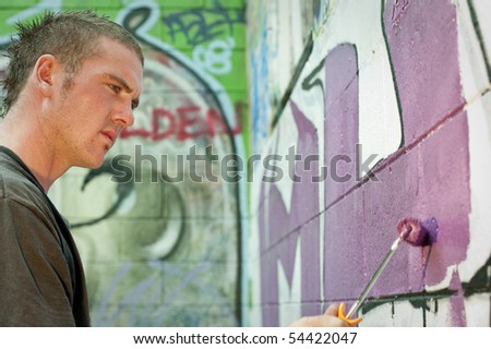 teenage boys tagging painting graffiti