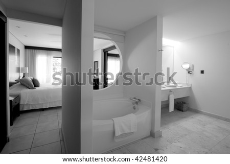 Black and white image of a hotel resort bathroom with jacuzzi