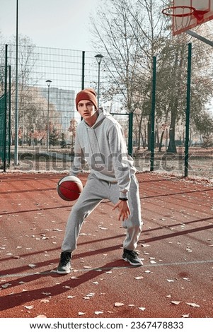 Similar – Image, Stock Photo young man playing basketball outdoor on bright sunny summer day