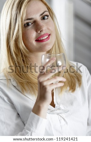 Young woman enjoying a glass of wine after work.