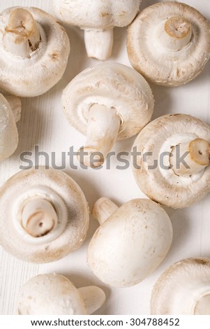 Fresh selection of chestnut mushrooms on a light wooden kitchen surface