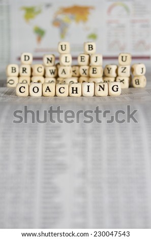 coaching word on newspaper background