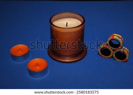 Image, Stock Photo One large candle and many small candles in a church