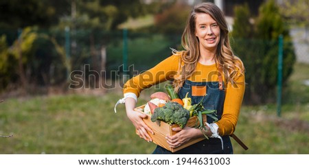 Similar – Image, Stock Photo Young woman harvesting fresh courgettes from the garden