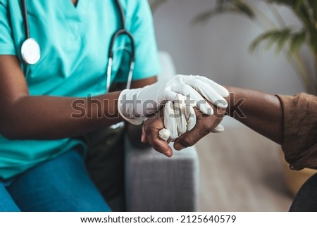 Cropped shot of a female nurse hold her senior patient's hand. Giving Support. Doctor helping old patient with Alzheimer's disease. Female carer holding hands of senior man Stock foto © 