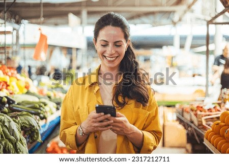 Similar – Image, Stock Photo Black woman sending a message on smartphone near sea in sunset