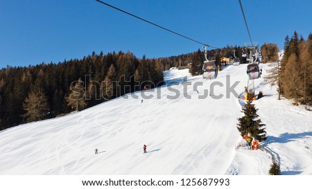 Gondola ski lift going up to the summit of Kronplatz Ski Resort, South Tyrol, Italy.