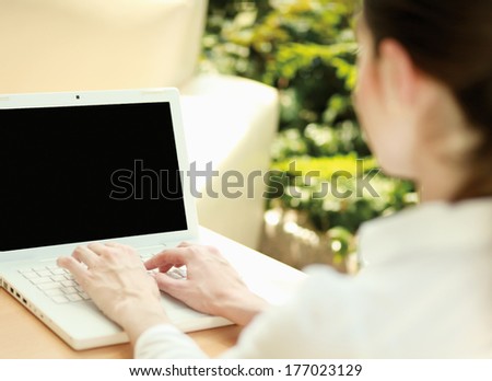 Beautiful  woman sitting on the sofa with laptop
