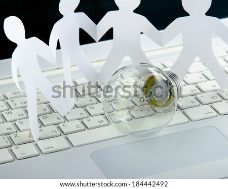 Light bulb and computer keyboard with paper people