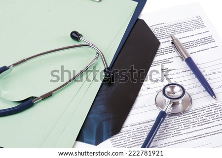 Stethoscope on medical billing statement on table, all text is anonymous.
