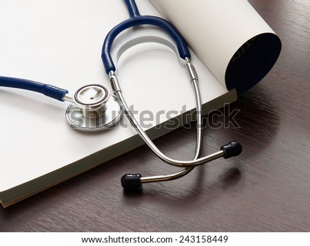 book and stethoscope isolated on white background