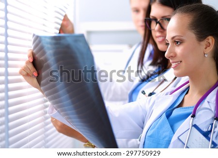 Young group of doctors looking at x-ray