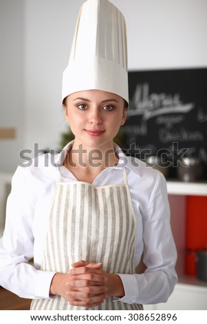 Chef woman portrait with  uniform in the kitchen