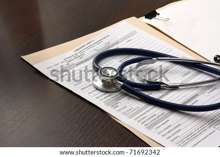 Close up of doctor\'s stethoscope and patient\'s medical information.