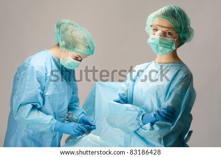 Image of surgeons near operation table with patient on it during operation