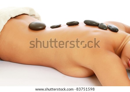 Youngh woman getting spa stone therapy, isolated on white