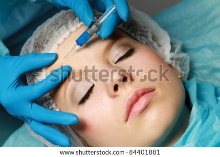 An injection to a woman\'s face, close-up