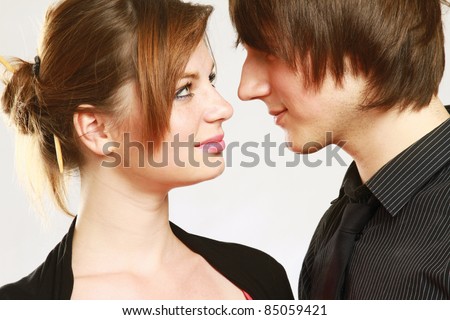 Portriat of a cute young couple looking at each other head to head isolated white background