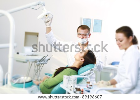 Young woman with dentist in a dental surgery. Healthcare, medicine.