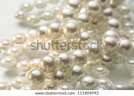 Shining string of white pearl in water