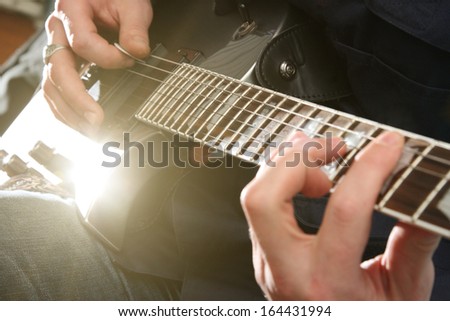 Electric guitar in male hands