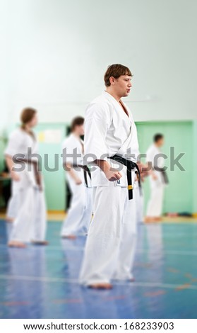 Master karate gives a lesson to his pupils