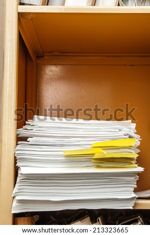 Office bookcase with stack of paper